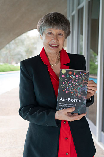 Professor Lidia Morawska holding a copy of the book ‘Air-borne’